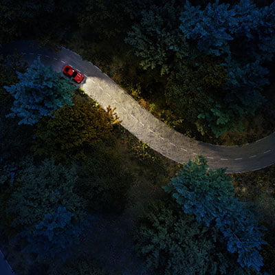 aerial shot of car driving on road at night