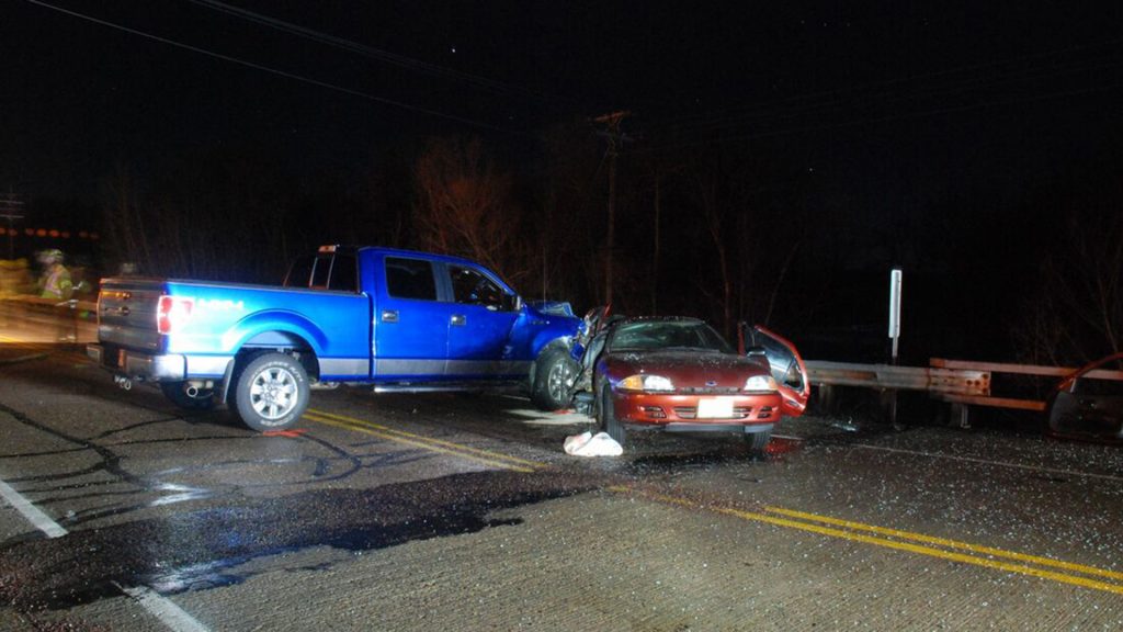 blue truck in collision with red sedan